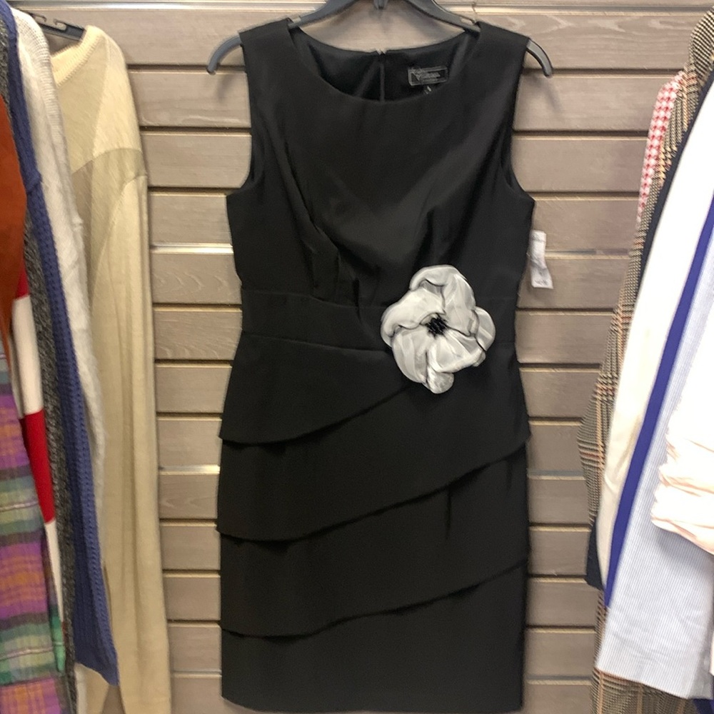 Black dress barn dress with white silk flower.